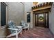 Brick patio with two chairs and a house entrance at 8100 E Camelback Rd # 14, Scottsdale, AZ 85251