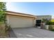 Tan house exterior showcasing a garage and landscaping at 8100 E Camelback Rd # 14, Scottsdale, AZ 85251