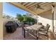 Relaxing patio with seating area, dining table and ceiling fan at 8100 E Camelback Rd # 14, Scottsdale, AZ 85251