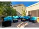 Private patio with blue cushioned seating and brick pavers at 8100 E Camelback Rd # 14, Scottsdale, AZ 85251