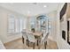 Bright dining area with a wood table and four gray chairs at 8533 E Monte Ave, Mesa, AZ 85209