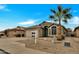 Single-story house with neutral exterior, two-car garage, and palm tree at 8533 E Monte Ave, Mesa, AZ 85209