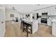 Modern kitchen with white cabinets, quartz countertops, and island at 8533 E Monte Ave, Mesa, AZ 85209