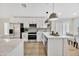 Modern kitchen with white cabinets, stainless steel appliances, and quartz countertops at 8533 E Monte Ave, Mesa, AZ 85209