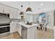 Eat-in kitchen with white shaker cabinets, quartz countertops, and an island at 8533 E Monte Ave, Mesa, AZ 85209