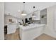 Modern kitchen with white cabinets, quartz countertops, and a large island at 8533 E Monte Ave, Mesa, AZ 85209