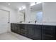 Modern bathroom with double vanity and marble counters at 8641 E Fillmore St, Scottsdale, AZ 85257