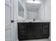 Elegant bathroom with dark vanity and marble top at 8641 E Fillmore St, Scottsdale, AZ 85257