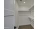 Large walk-in closet with shelves and hanging rods at 8641 E Fillmore St, Scottsdale, AZ 85257