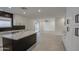 Open concept kitchen with white cabinets, marble countertops, and view to backyard at 8641 E Fillmore St, Scottsdale, AZ 85257