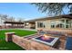 Expansive backyard with firepit, and outdoor kitchen at 8793 W Villa Lindo Dr, Peoria, AZ 85383