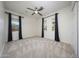 Bright bedroom with neutral carpeting and large windows at 8793 W Villa Lindo Dr, Peoria, AZ 85383