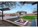 Fire pit with seating overlooking pool and backyard at 8793 W Villa Lindo Dr, Peoria, AZ 85383