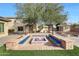 Relaxing fire pit with built-in seating in the backyard at 8793 W Villa Lindo Dr, Peoria, AZ 85383