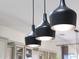 Stylish kitchen lighting with three black pendant lights at 8793 W Villa Lindo Dr, Peoria, AZ 85383