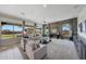 Spacious living room with large windows, modern furniture, and a stone accent wall at 8793 W Villa Lindo Dr, Peoria, AZ 85383