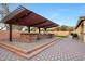 Entertaining outdoor kitchen with pergola and built-in appliances at 8793 W Villa Lindo Dr, Peoria, AZ 85383