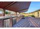 Pergola-covered outdoor kitchen with stainless steel appliances at 8793 W Villa Lindo Dr, Peoria, AZ 85383