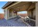 Relaxing covered patio with fireplace, seating, and TV at 8793 W Villa Lindo Dr, Peoria, AZ 85383