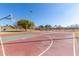 Outdoor basketball court with two hoops, surrounded by trees and grass at 9030 S Maple Ave, Tempe, AZ 85284