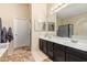 Bathroom boasts double sinks and a large mirror at 9030 S Maple Ave, Tempe, AZ 85284