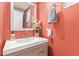 Small bathroom with updated vanity and coral walls at 9030 S Maple Ave, Tempe, AZ 85284