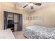 Bright bedroom featuring a ceiling fan and window shutters at 9030 S Maple Ave, Tempe, AZ 85284