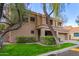 Two-story house with a tan exterior, two-car garage, and landscaped front yard at 9030 S Maple Ave, Tempe, AZ 85284