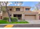 Two-story house with a tan exterior, two-car garage, and landscaped front yard at 9030 S Maple Ave, Tempe, AZ 85284