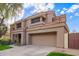 Two-story house with a tan exterior, two-car garage, and landscaped front yard at 9030 S Maple Ave, Tempe, AZ 85284