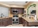 Kitchen with granite countertops, stainless steel appliances, and dark wood cabinets at 9030 S Maple Ave, Tempe, AZ 85284