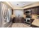 Kitchen with stainless steel appliances and granite countertops at 9030 S Maple Ave, Tempe, AZ 85284