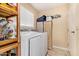 Functional laundry room with washer, dryer, and storage shelves at 9030 S Maple Ave, Tempe, AZ 85284