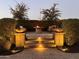 Evening view of backyard patio with fire pit, fountain, and seating at 9364 W Cashman Dr, Peoria, AZ 85383