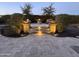 Evening view of backyard patio with fire pit, fountain, and seating at 9364 W Cashman Dr, Peoria, AZ 85383