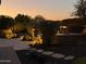 Evening view of a backyard patio with fire pit and seating area at 9364 W Cashman Dr, Peoria, AZ 85383