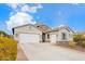 Single-story home with neutral exterior, two-car garage, and landscaped yard at 9364 W Cashman Dr, Peoria, AZ 85383