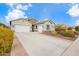 Single-story home with neutral exterior, two-car garage, and landscaped yard at 9364 W Cashman Dr, Peoria, AZ 85383