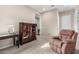 Well-lit hallway with a comfortable recliner and a wooden cabinet at 9364 W Cashman Dr, Peoria, AZ 85383