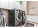 Bright laundry room, featuring a washer, dryer, and utility sink at 9364 W Cashman Dr, Peoria, AZ 85383