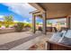 Relaxing covered patio with seating area, adjacent to a hot tub and putting green at 9364 W Cashman Dr, Peoria, AZ 85383