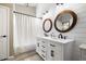 Modern bathroom featuring shiplap walls, dual sinks, wood framed mirrors and elegant lighting at 9713 E Onza Ave, Mesa, AZ 85212