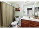 Functional bathroom featuring a shower with a tub and a wooden vanity with updated fixtures at 9713 E Onza Ave, Mesa, AZ 85212