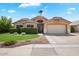 Charming single-story home featuring a well-manicured lawn and a two-car garage on a sunny day at 9713 E Onza Ave, Mesa, AZ 85212