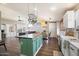 Spacious kitchen with a green kitchen island, stainless steel appliances and dark hardwood floors at 9713 E Onza Ave, Mesa, AZ 85212