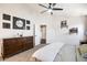 Cozy main bedroom with a ceiling fan, carpeted floors, and a dark wood dresser at 9713 E Onza Ave, Mesa, AZ 85212