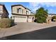 Two-story house with three-car garage and landscaped front yard at 9830 E Acacia Dr, Scottsdale, AZ 85260