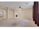 Spacious living room featuring a fireplace and neutral carpeting at 9830 E Acacia Dr, Scottsdale, AZ 85260