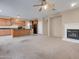 Living room with fireplace and view into kitchen at 9830 E Acacia Dr, Scottsdale, AZ 85260