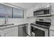 Modern kitchen featuring stainless steel appliances and white cabinetry at 9990 N Scottsdale Rd # 1048, Paradise Valley, AZ 85253